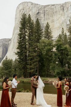 a couple getting married in front of a mountain