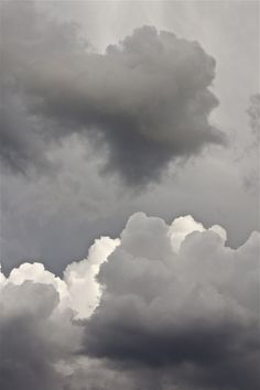 an airplane is flying in the cloudy sky