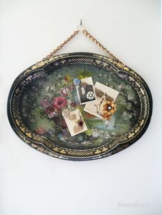 a painting hanging on the wall with cards and flowers