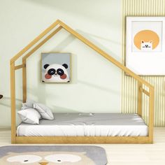 a room with a bed, rug and pictures on the wall above it that has a panda bear face