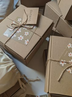 several brown boxes tied with twine and decorated with flowers