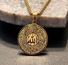 Stainless Steel Arabic Allah God Necklace | Christian, Islamic | Gold Tone, 24 inch Chain Beautiful necklace, now available in gold! Iconic look. Stainless steel construction. The chain is 60 cm in length (~ 24 inches). The pendant has a diameter of 2.4 centimeters. The closing mechanism of the chain is shown in the last picture.  The pendant has reflective inscription on its face. Please view the pictures to get an idea of this. In Arabic, the word "God" is displayed on the front. God Necklace, Islamic Jewelry, Necklace Christian, Allah God, In Arabic, Men Jewelry, Islam Facts, Beautiful Necklace, Steel Construction