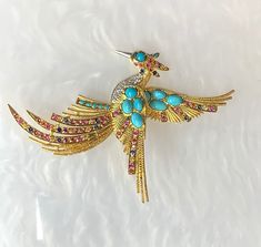 "Bird Brooch - Bird Pin - Vintage Brooch - Turquoise Pin - Turquoise Brooch - Rainbow Sapphire Pin - Vintage Jewelry - Bird Jewelry A collectors item for all the animal lovers out there. An exceptional and vibrant yellow gold vintage pin with intricate detailing: featuring over 14 carats of multi colored red, yellow, orange and blue sapphires, 8 oval turquoise and genuine diamonds. *Total weight: 30.50 grams *Measurements: Length: approximately 3\" Width: approximately 4 1/2\"" Luxury Turquoise Brooches, Luxury Turquoise Brooches For Gift, Luxury Multicolor Brooches As Gift, Luxury Multicolor Brooches For Gifts, Dainty Earrings Studs, Antique Emerald Ring, Emerald Ring Vintage, Rainbow Sapphires, Bird Pins