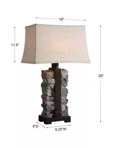 a table lamp with a stone block base and a light shade on top of it