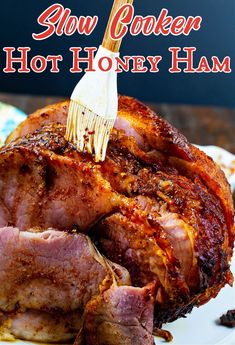 slow cooker hot honey ham on a white plate with the words slow cooker hot honey ham