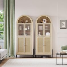 a living room filled with furniture next to a white couch and green curtained windows