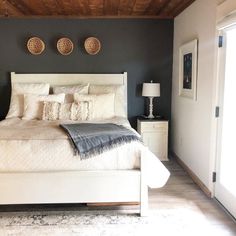 a large bed sitting in a bedroom on top of a hard wood floor