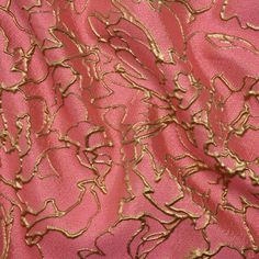 pink and gold brocaded fabric with large, wavy lines on the top right side