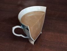 a coffee cup with a paper triangle on it