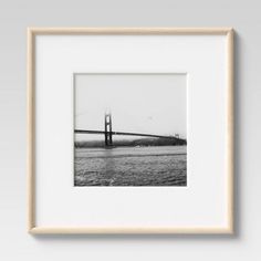 a black and white photo of the golden gate bridge in san francisco, california framed on a wall