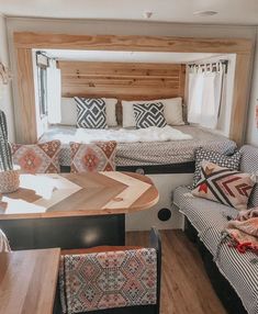 a living area with couches, tables and chairs in a mobile home or camper