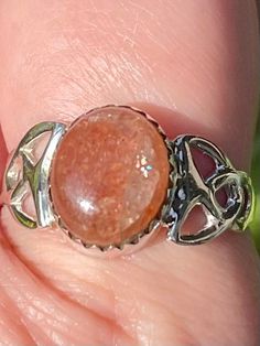 Celtic Sunstone Ring Luck Sunstone is the stone of luck and good fortune. It clears and energizes the chakras. This stone heightens intuition and allows your real self to shine through. It removes fear and alleviates stress. Sunstone encourages independence and originality. This stone is especially helpful to those who have a difficult time saying “No” to others. It facilitates self-empowerment and independence. Sunstone acts as an antidepressant and increases self-worth and confidence. This sto Spiritual Sunstone Jewelry As A Gift, Spiritual Sunstone Jewelry For Gift, Spiritual Round Crystal Healing Ring, Spiritual Healing Crystal Ring, Silver Crystal Ring For Healing, Adjustable Spiritual Crystal Ring With Round Stone, Spiritual Large Stone Crystal Promise Ring, Spiritual Healing Rings With Natural Stones, Sterling Silver Crystal Ring For Healing