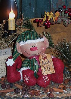 there is a christmas decoration on the table next to a candle and some other decorations