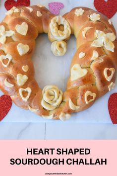 a heart shaped sourdough challah with hearts around it