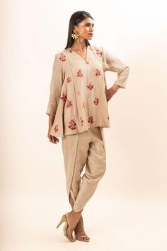 Beige tunic with scattered floral embroidery. Paired with a dhoti pant.
Components: 2
Pattern: Embroidery
Type Of Work: Floral
Neckline: V Neck
Sleeve Type: Three Quarter Sleeves
Fabric: Tunic: Chanderi, Dhoti Pant: Bamber silk, Lining: Mul cotton
Color: Beige
Other Details: 
Attached inner lining
Closure: Elastic
Occasion: Work,Resort - Aza Fashions Dhoti Pants, Pant For Women, Embroidery Floral, Pattern Embroidery, Embroidered Tunic, Three Quarter Sleeves, Quarter Sleeve, Aza Fashion, Fashion Set