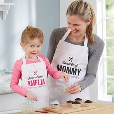 a mother and daughter preparing cupcakes in the kitchen