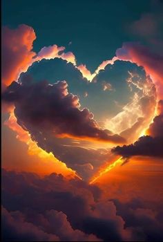 a heart shaped cloud in the sky at sunset