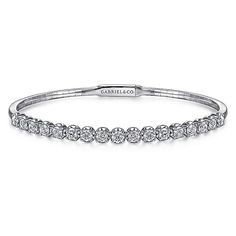 The perfect addition to your ring stacking can be found in this Demure collection bangle that is a chic showcase of modest glamor. Its delicate foundation is made of a delicate base of 14K white gold. Halfway towards the bangle's centerpiece is a extravagant row of round 1.93 ct diamond stations. Giving off an illuminating sparkle, this bangle is versatile enough to wear solo or combine with an assortment of your favorite stackable bracelets. Cheap White Bangle Jewelry, Elegant Diamond White Stackable Bracelets, Modern White Gold Wedding Bangle, Elegant Stackable Diamond Bangle Bracelet, Elegant Stackable Diamond Bracelet For Wedding, Elegant Diamond Bracelet With Halo For Formal Occasions, Elegant Formal Diamond Bracelet With Halo, Elegant Halo Diamond Bracelet For Formal Occasions, Stackable White Gold Tennis Bracelet Fine Jewelry