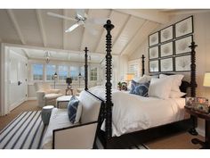 a bedroom with a canopy bed and pictures on the wall