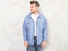 "Check out this vintage 90's men casual spring jacket in blue made of cotton. Classic look and fit for everyday wear. Vintage condition level 4 (very minor signs of wear) * MODEL is 6.0 ft (1.80 m) tall, size S / M - and he wears the size available. SIZE: Marked size: L. To be sure it would fit you, please check the measurements below. FLAT Measurements: Length: 29\" / 74 cm Armpit to armpit: 24 1/2\" / 62 cm SKU: M8060 (AMP) # As all our garments, this is previously washed, ironed and ready to Spring Cotton Windbreaker For Outdoor, Casual Cotton Windbreaker With Relaxed Fit, Casual Cotton Track Jacket For Outdoor, Casual Cotton Windbreaker For Spring, 90s Style Windbreaker With Pockets For Spring, 90s Cotton Windbreaker For Outdoor, Casual Spring Track Jacket For Outdoor, 90s Style Track Jacket For Spring Outdoor, 90s Style Spring Outdoor Track Jacket