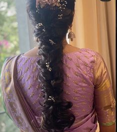 a woman with long hair wearing a purple sari