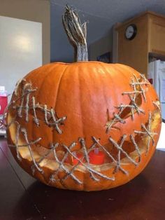 a carved pumpkin with barbed wire on it