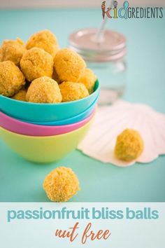 a bowl filled with yellow bliss balls on top of a table