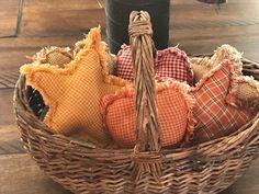 a wicker basket filled with different types of cloths and other decorative items on top of a wooden floor