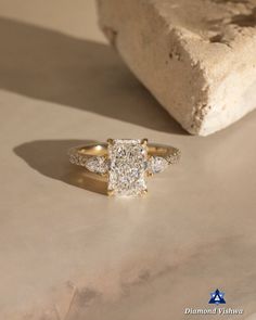 a diamond ring sitting on top of a stone