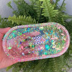 someone is holding a pink and green case with glitter on it that says dance out easy