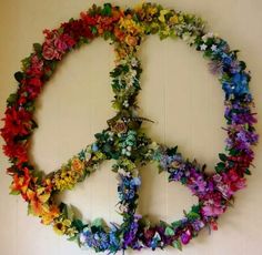 a peace sign made out of flowers and leaves