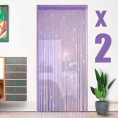 there is a purple curtain in front of a white wall with the number two on it