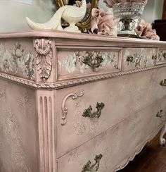 an antique dresser with flowers on it