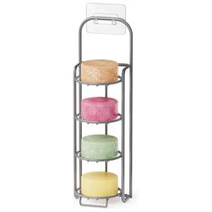 three tiered metal rack with four different colored cakes on it's bottom shelf