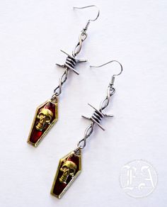 made from stained alloy metal with a size of 3 inches long and 2 cm in with. Edgy Metal Earrings With Ear Wire, Nickel-free Metal Alternative Style Earrings, Alternative Style Nickel-free Metal Earrings, Nickel-free Metal Earrings In Alternative Style, Edgy Halloween Jewelry, Punk Style Metal Jewelry With Ear Wire, Edgy Adjustable Earrings For Halloween, Edgy Drop Earrings For Halloween, Edgy Halloween Drop Earrings