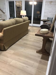 a living room with hard wood floors and white walls