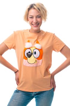 a woman wearing an orange shirt with a cartoon character on it