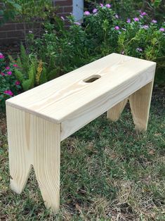 a small wooden bench sitting in the grass