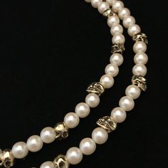 This necklace is a combination of new and vintage pieces. Circa 1960 faux pearls are mixed with twenty contemporary, gold plated skull beads. The skulls and pearls are both about the same size, 3/8 inch, or 8 mm. It has been strung on thick beading wire and both strands end in a vintage, gold plated closure component original to the necklace. A raw brass skull has been added to the large, 1 inch tongue in socket closure. It is a double strand necklace measuring 16 and 17 inches.  There are twent Beaded Metal Pearl Necklace With Round Beads, Gold Beaded Metal Pearl Necklace, Metal Double Strand Jewelry Gift, Double Strand Metal Jewelry For Gifts, Classic Metal Jewelry With Pearl Chain, Classic Metal Pearl Chain Jewelry, Classic Pearl Charm Jewelry For Party, Spiritual Single Strand Round Jewelry, Vintage Pearl-embellished Jewelry For Formal Occasions