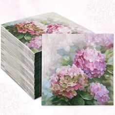 a stack of cards with pink and green flowers on the front, sitting next to each other