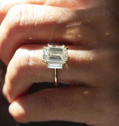 5.94 TC Elongated Emerald Cut Trilogy-14k Solid Yellow Gold-Baguette Cut Sides-Engagement Ring-Three Stone Ring-In Fashion-Celeb Style Ring ❤ ITEM DETAILS:- ✦ Brand: The American Gold House (TAGH) ✦ Handmade, high-quality item! ✦ Material: Solid 10K/14K/18K Gold, 950 Platinum and 925 Sterling Silver ✦ Diamond Type: Moissanite Diamond ✦ Diamond Cut: 12x8 MM Elongated Emerald ✦ Width of Band: 1.8 MM (Bottom) ✦ Diamond Clarity: VVS/VS ✦ Center Diamond: 12x8  MM 5.34 CT Elongated Emerald ❤ SIDE STONES:-  ✦ 2 X 0.30 CT Straight Baguette Cut Colorless Moissanite                                                                                                                                                                            ------------------------------------------------------------------ Elongated Baguette Engagement Ring, Chris Cut Diamond, Emerald Trilogy Engagement Ring Gold, Three Stone Engagement Rings Baguette, Side Baguette Engagement Ring, Radiant Engagement Ring With Baguettes, Engagement Rings Two Stone, Emerald Trilogy Engagement Ring, Emerald Cut Three Stone Engagement Ring