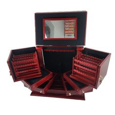 an open red jewelry box with drawers and mirror on the top, sitting in front of a white background