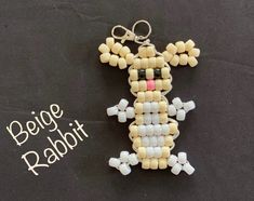 a key chain made out of beads with the word bead rabbit on it's side