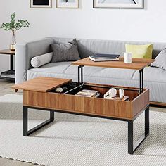 a living room with a couch, coffee table and pictures on the wall