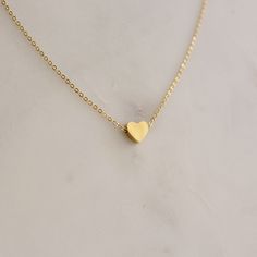 Dainty Heart Pendent Necklace  - This listing is for pair os the Dainty Heart Pendent Necklace. Perfect for everyday and layering - Length: 16" + 2" extender  - Base Material: High Quality Stainless Steel - Finish: 18K Gold - Measurements: Heart - 7mm/7mm  - Nickel Free and Tarnish Free - All our jewelry is packaged in gift ready boxes. If you would like multiple items from your order packaged separately please let us know! © 2024 Generation of Daughters Heart Charm Pendant Necklace For Valentine's Day, Gold Heart Pendant Necklace With Heart Print, Simple Necklace With Heart Charm As A Gift, Minimalist Heart Necklace With Adjustable Chain, Gold Heart Necklace With Heart Pendant, Gold Heart Necklace With Heart Print For Valentine's Day, Minimalist Heart-shaped Jewelry With Heart Detail, Heart Shaped Clavicle Chain Necklace, Valentine's Day Heart Charm Necklace For Jewelry Making