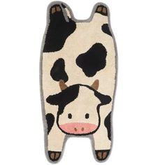 a black and white cow rug with brown spots on it's face, sitting in front of a white background