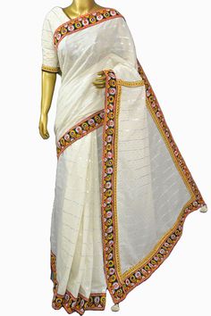 The hand-picked collection from the handloom weavers comes with this silver and golden buti work on the pallu of the chanderi cotton silk saree with a fascinating Kathiawadi-style dignified border with thorough mirror embroidery work to match its appearance. Color: A shade of offwhite color Technique: Comes with all-over traditional zari butta weaving on the pallu with Kathiawadi style border and mirror embroidery work allover. Fabric: Chanderi Cotton Traditional Silver Tissue Silk Pre-draped Saree, White Cotton Silk Pre-draped Saree For Festivals, White Cotton Silk Pre-draped Saree With Zari Work, White Embroidered Pre-draped Saree For Navratri, White Dola Silk Pre-draped Saree For Wedding, Dola Silk Pre-draped Saree With Embroidered Border For Puja, Transitional Pre-draped Saree With Cutdana For Traditional Ceremonies, Traditional Ceremonial Pre-draped Saree With Cutdana, White Chanderi Pre-draped Saree With Zari Work