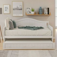 a white daybed sitting on top of a hard wood floor