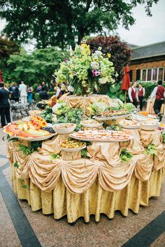 an elaborately decorated table with plates of food on it