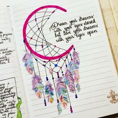 an open notebook with writing on it and a drawing of a dream catcher in the middle